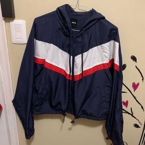 Navy blue zipped windbreaker with hood.